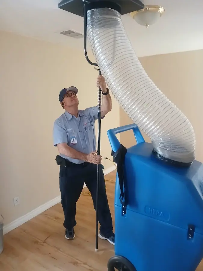 Furnace Tune-Up technician using HEPA equipment in Banning